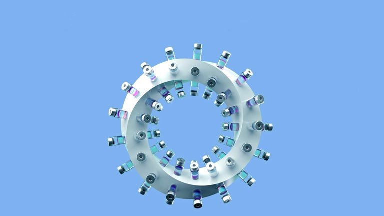 A twisting ring with vaccine vials affixed to its perimeter.